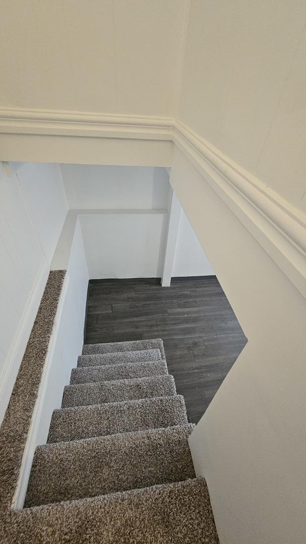 stairs with hardwood / wood-style flooring