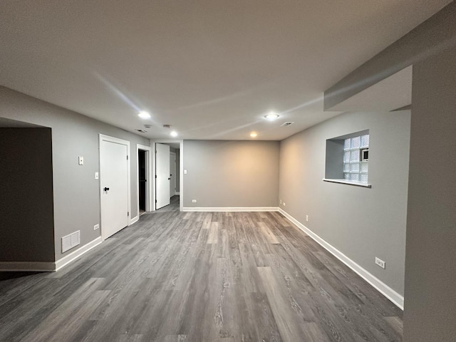 basement with dark hardwood / wood-style floors