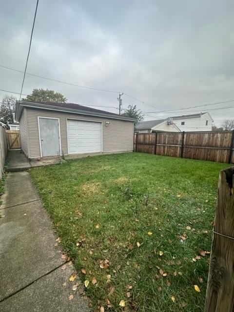 view of yard featuring a garage and an outdoor structure