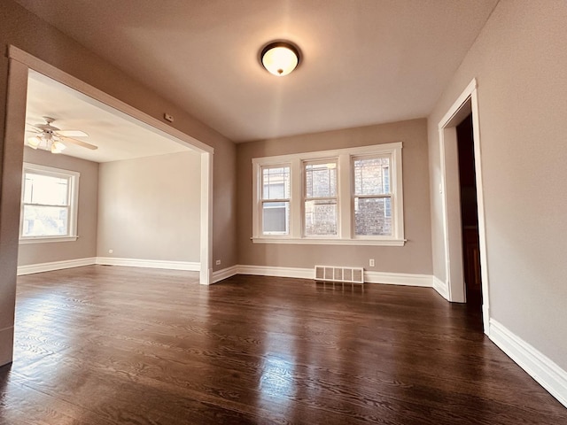 unfurnished room with ceiling fan and dark hardwood / wood-style flooring