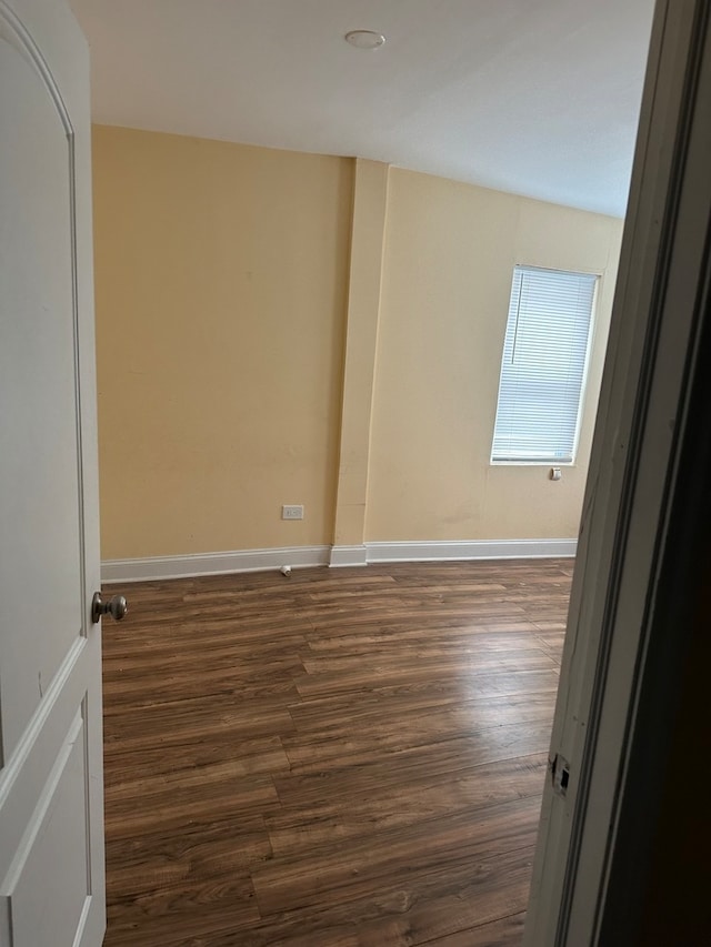 empty room with dark hardwood / wood-style floors