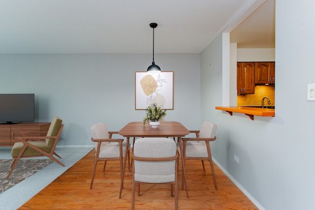 dining area with light wood-type flooring