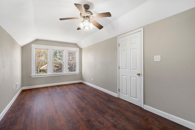 additional living space featuring dark hardwood / wood-style flooring, vaulted ceiling, and ceiling fan