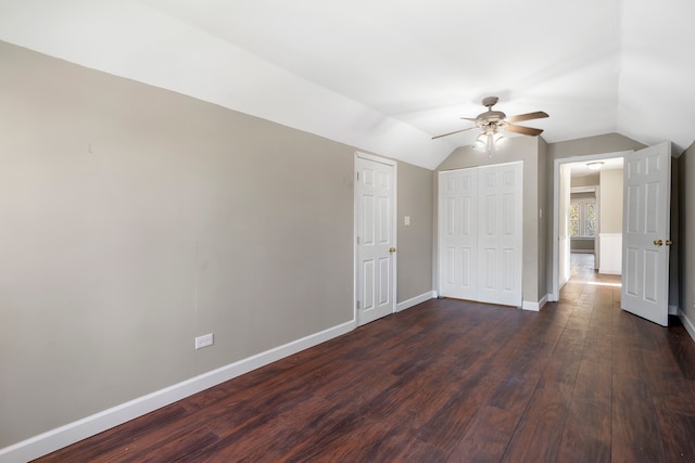 interior space featuring vaulted ceiling, ceiling fan, and dark wood-type flooring