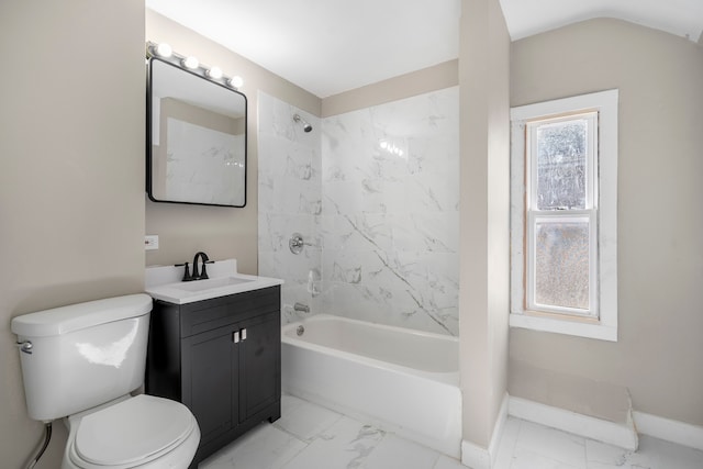 full bathroom with tiled shower / bath, vanity, vaulted ceiling, and toilet