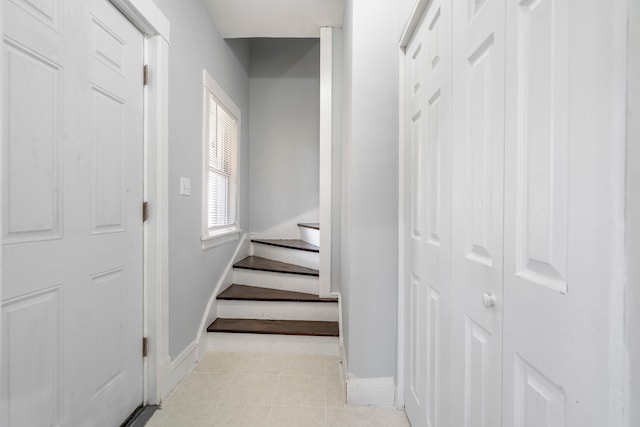 staircase featuring tile patterned flooring