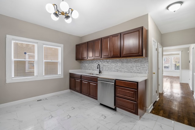 kitchen with decorative backsplash, sink, light hardwood / wood-style flooring, an inviting chandelier, and dishwasher