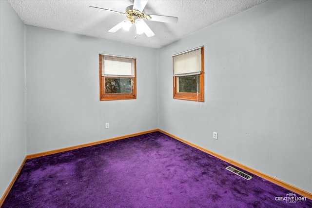 spare room featuring a textured ceiling, carpet floors, and ceiling fan