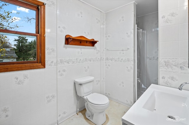 bathroom with a healthy amount of sunlight, toilet, and tile walls