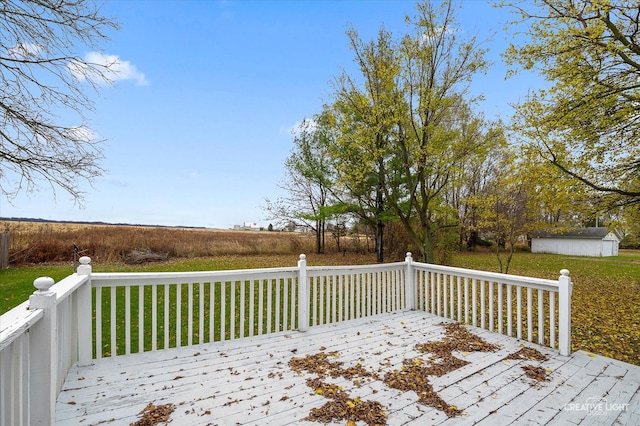 wooden deck featuring an outdoor structure and a yard