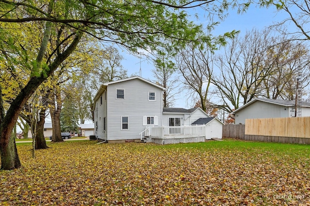 rear view of property featuring a deck