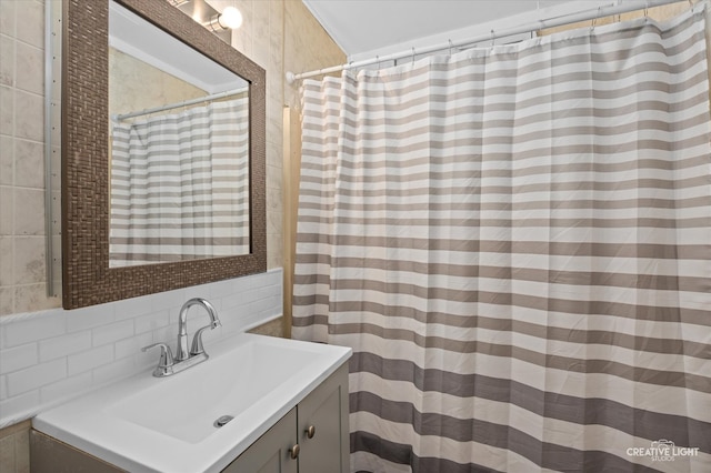 bathroom featuring tasteful backsplash, vanity, and tile walls