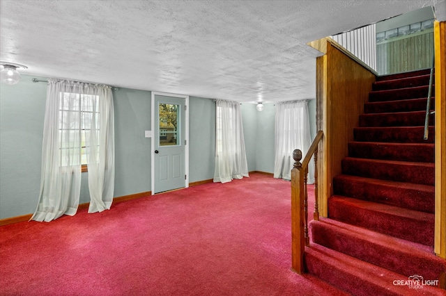 interior space with carpet flooring and a textured ceiling