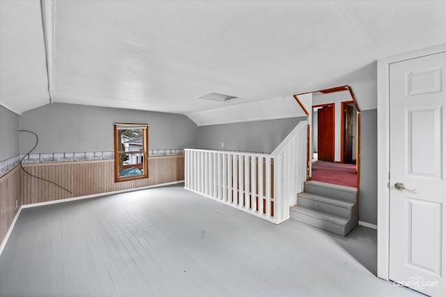 bonus room featuring wood-type flooring and vaulted ceiling