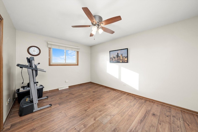 workout area with hardwood / wood-style flooring and ceiling fan