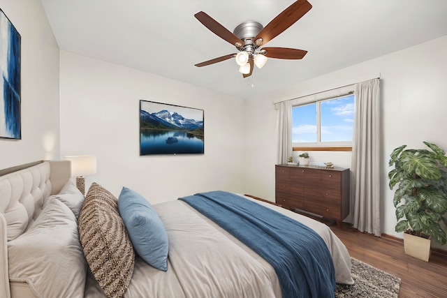 bedroom with dark hardwood / wood-style floors and ceiling fan