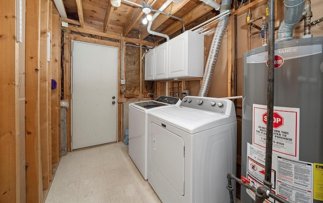 laundry room featuring washer and dryer, gas water heater, and cabinets