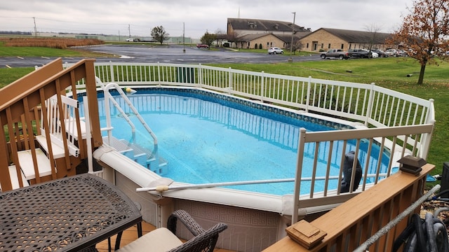 view of swimming pool featuring a wooden deck