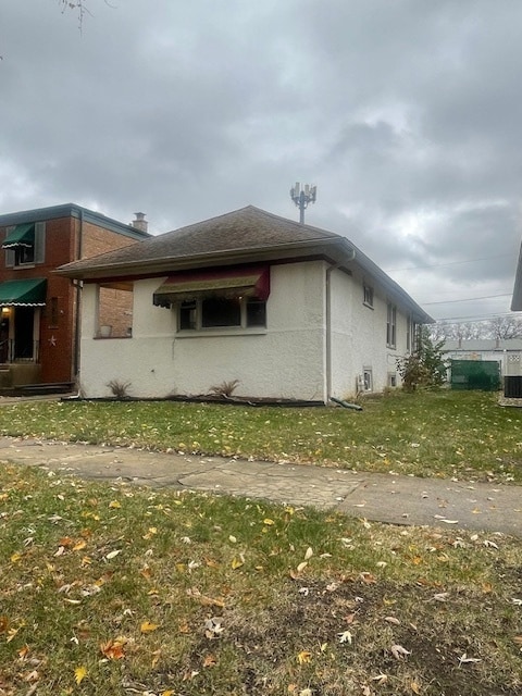 view of home's exterior with a lawn