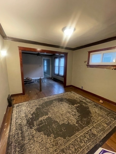 empty room featuring dark hardwood / wood-style floors and crown molding