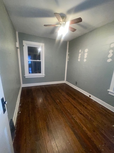 spare room featuring ceiling fan and dark hardwood / wood-style floors