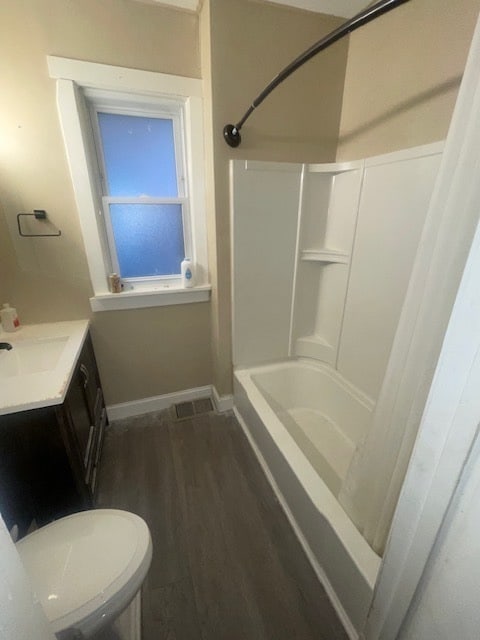 bathroom with hardwood / wood-style floors, vanity, and toilet