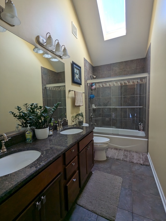 full bathroom with vaulted ceiling with skylight, vanity, toilet, shower / bath combination with glass door, and tile patterned flooring