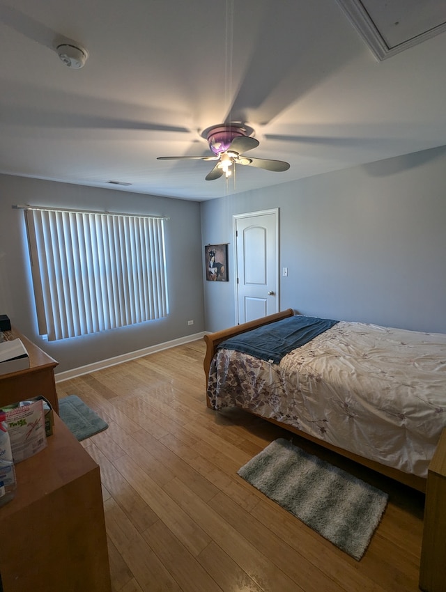 bedroom with ceiling fan and light hardwood / wood-style floors