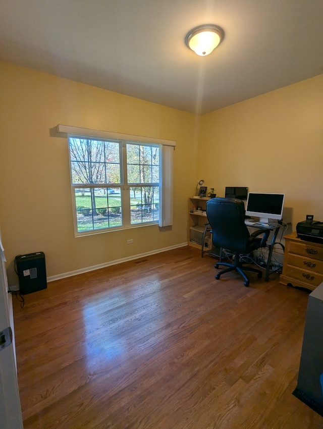 home office with wood-type flooring