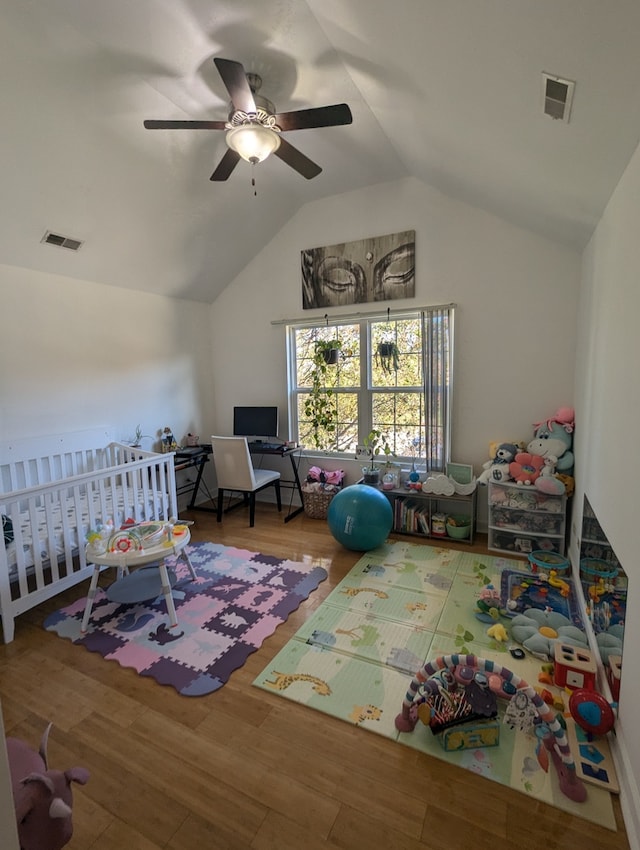 playroom with ceiling fan, lofted ceiling, and hardwood / wood-style flooring