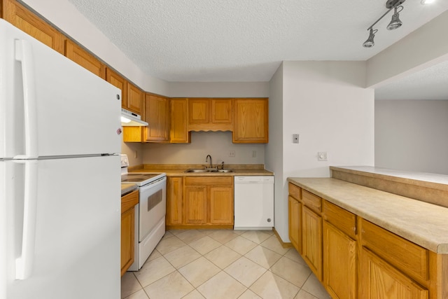 kitchen featuring white appliances, kitchen peninsula, light tile patterned floors, a textured ceiling, and sink