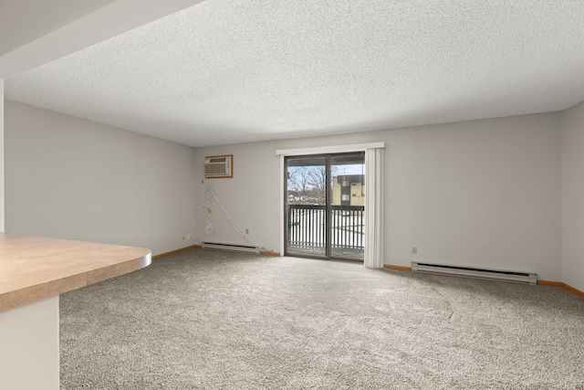 interior space with a textured ceiling, a wall unit AC, and a baseboard heating unit