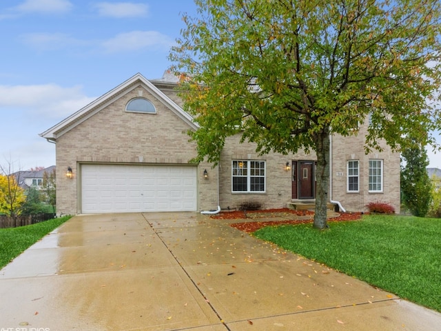 view of front of house with a front yard and a garage