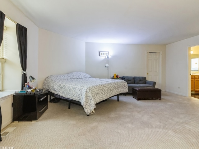 carpeted bedroom with ensuite bathroom