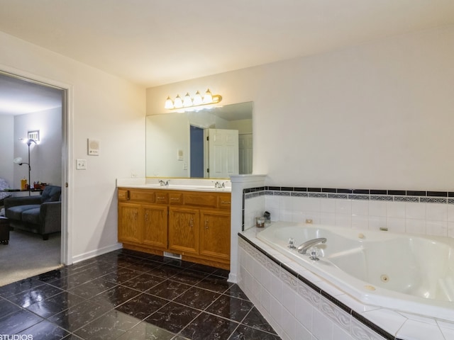 bathroom with tiled tub and vanity