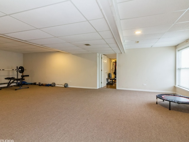 unfurnished room featuring carpet flooring and a paneled ceiling