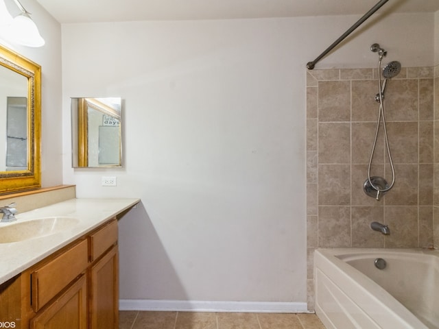 bathroom with tile patterned floors, vanity, and tiled shower / bath