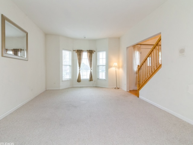 unfurnished room with light colored carpet