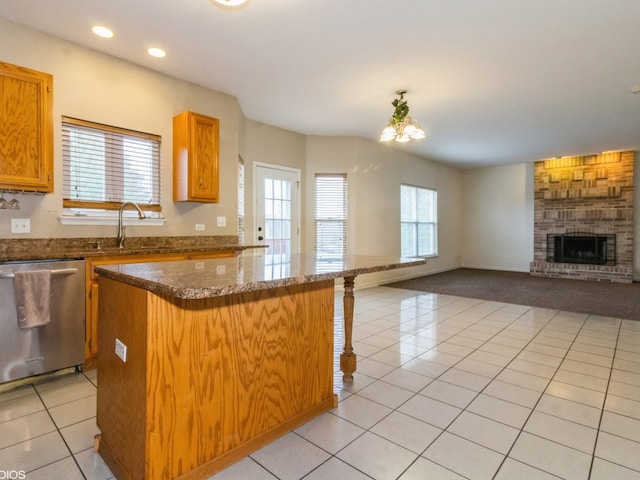 kitchen with a wealth of natural light, dishwasher, a kitchen island, and a notable chandelier