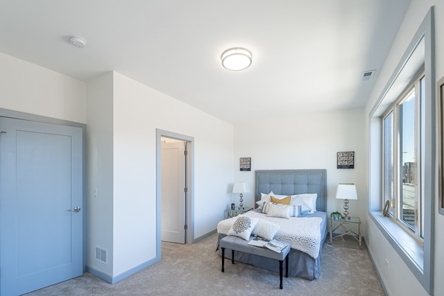 bedroom with light colored carpet