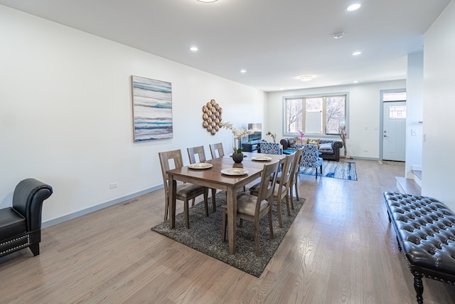 dining area with light hardwood / wood-style floors