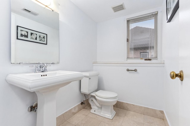 bathroom with tile patterned flooring and toilet