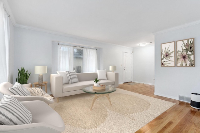 living room with light hardwood / wood-style floors and ornamental molding