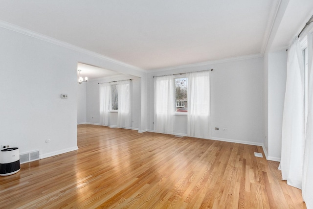 unfurnished room featuring a chandelier, light hardwood / wood-style flooring, and crown molding