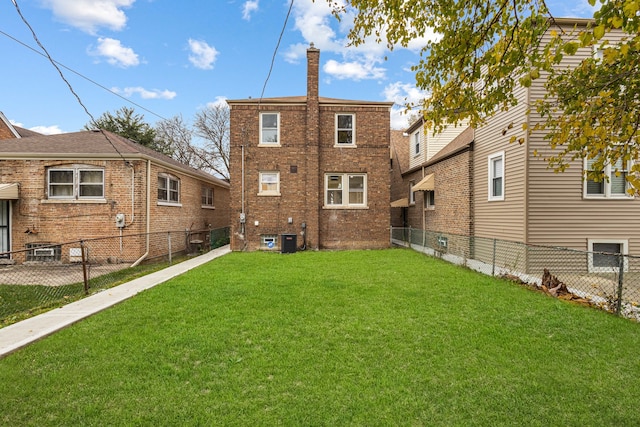 back of house featuring a yard and cooling unit