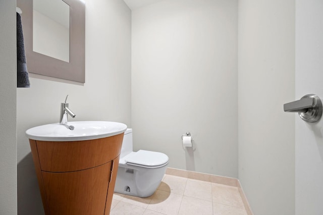 bathroom featuring vanity, tile patterned floors, and toilet