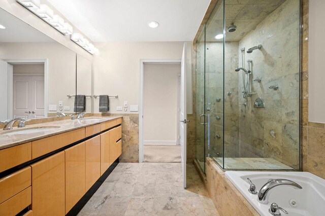 bathroom with vanity and independent shower and bath