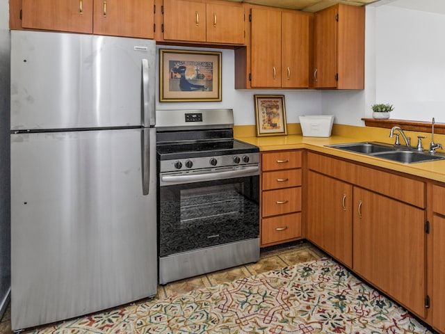 kitchen featuring sink, light tile patterned floors, and stainless steel appliances