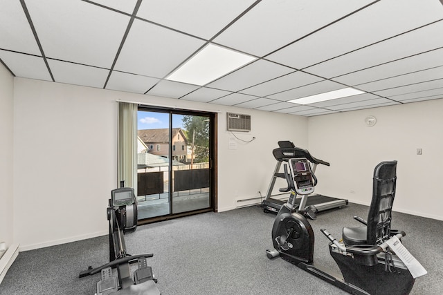 workout room with carpet, a drop ceiling, and a wall unit AC