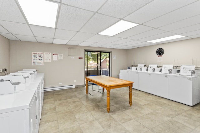 washroom with baseboard heating and washing machine and clothes dryer